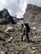 Martin backpacking up the talus approach to the CMC camp