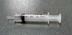 a syringe with 3 ml of water and no air bubbles.