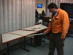 a meter stick balanced on a watchglass is rotated by electrostatic repulsion