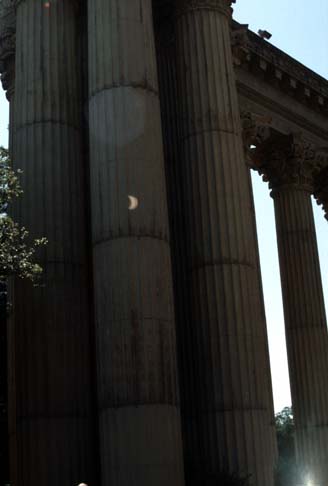 An image of a partial eclipse onn the pillars of the Palace of Fine Arts.